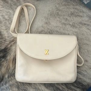 Super elegant bag By Paloma Picasso. Cream with a magnetic closure.